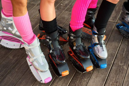 group of womens legs in jumping boots. outdoor fitness workout in group
