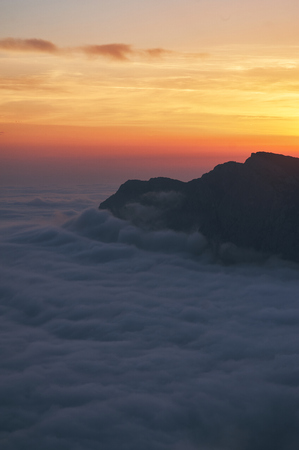 beautiful sunset above the clouds in the mountains. stunned landscape background with copy space. aerial mountain viewの写真素材