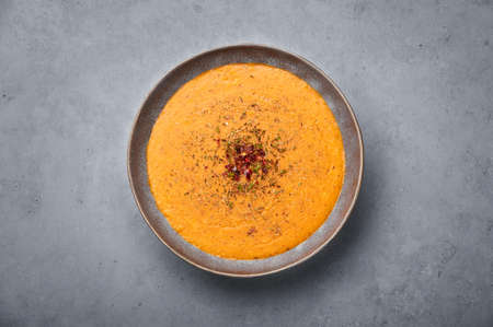 Ezogelin Soup in gray bowl on concrete table top. Turkish cuisine traditional dish with red lentils, bulgur and riceの写真素材