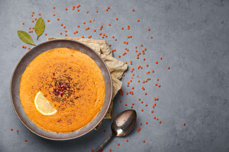 Ezogelin Soup in gray bowl on concrete table top. Turkish cuisine traditional dish with red lentils, bulgur and rice. Copy space. Top viewの写真素材