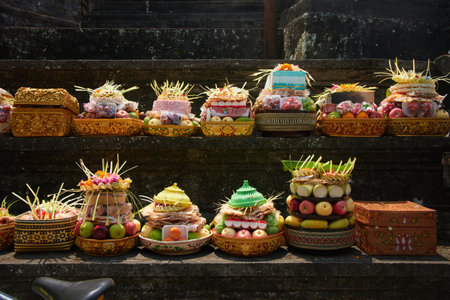 Traditional Balinese religious offerings in culorful hand-crafted boxes and baskets with food and...
