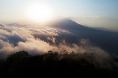 Agung Volcano rising above the clouds at sunset â a stunning aerial view of Bali's iconic landscapeの写真素材