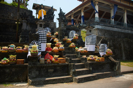 Traditional Balinese religious offerings in culorful hand-crafted boxes and baskets with food and decorationsの写真素材