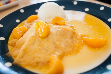 Appetizers consisted ice cream, orange, and crepesの写真素材