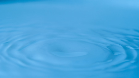 Rings on a water surface caused by a falling drop.の写真素材