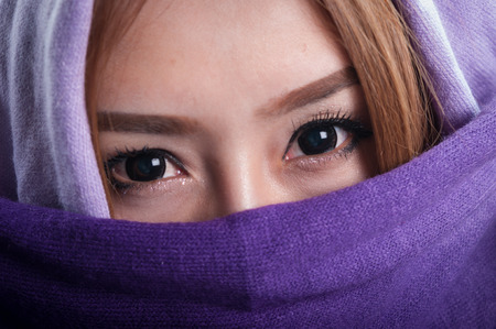 Beautiful young woman with shawl on headの写真素材