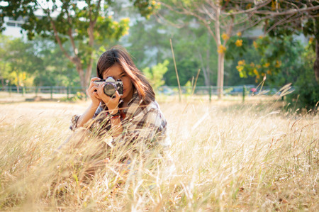 Leisure activities of girl photographer in fine weatherの写真素材