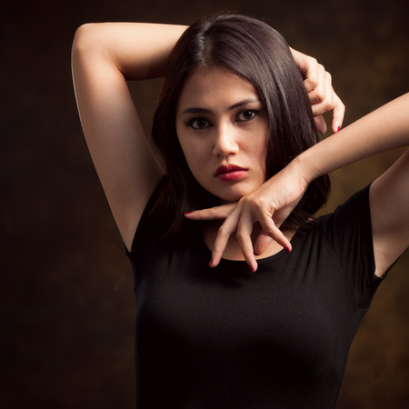 Glamorous young sexy woman on brown backgroundの写真素材