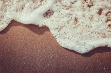 Soft wave of the sea on the sandy beach, Retro effectの写真素材