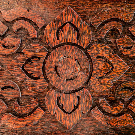 Thai art carving on window made by plank woodの写真素材