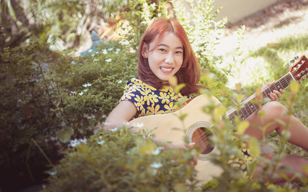 Musician woman and her guitar in good dayの写真素材