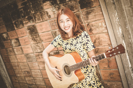 Musician woman and her guitar in good dayの写真素材