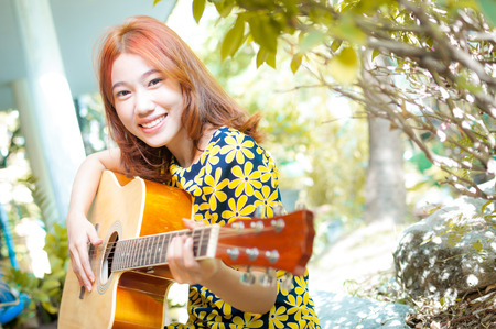 Musician woman and her guitar in good dayの写真素材