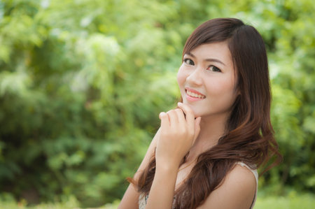 Positive post of smiling woman in the parkの写真素材