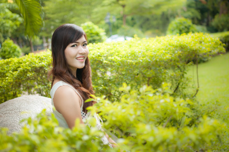 Positive post of smiling woman in the parkの写真素材