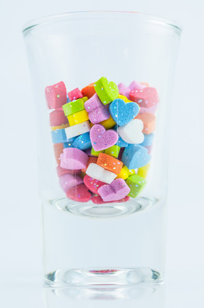 Heart shape in the glass on white backgroundの写真素材
