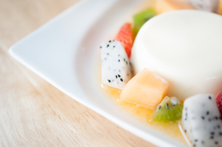 italian panna cotta dessert with strawberry, kiwi and cantaloupeの写真素材