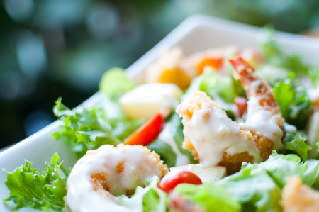Healthy green salad with fried shrimp in a bowlの写真素材