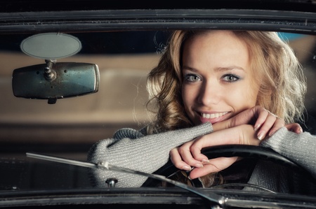 pretty woman in an old carの写真素材