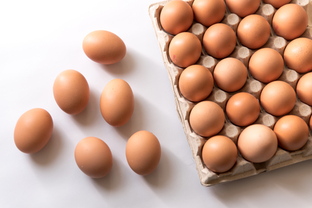 chicken eggs, packaged, eggs placed on a white background, eggs outside the packageの写真素材