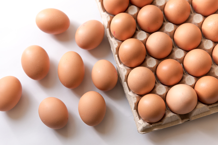 chicken eggs, packaged, eggs placed on a white background, eggs outside the packageの写真素材