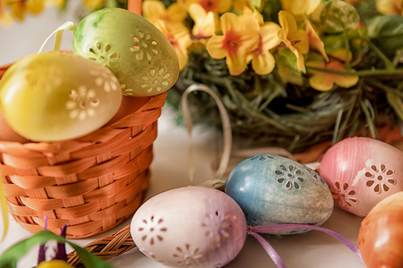 Easter, Easter decorations, painted eggs in a basket, and a backpack on a white backgroundの写真素材