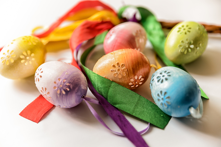 Easter, Easter decorations, painted eggs in a basket, and a backpack on a white backgroundの写真素材