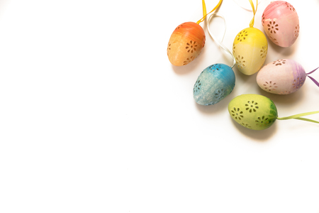 Easter, Easter decorations, painted eggs in a basket, and a backpack on a white backgroundの写真素材