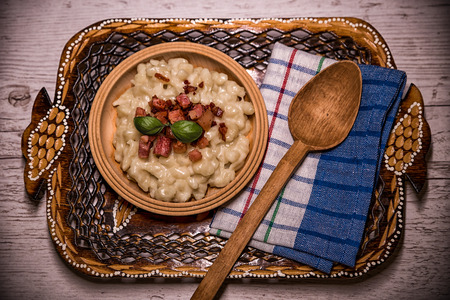 Slovak traditional dishes, potato gnocchi, bryndza, on wooden pancakes, potatoes, eggs. milk, sheep's cheeseの写真素材
