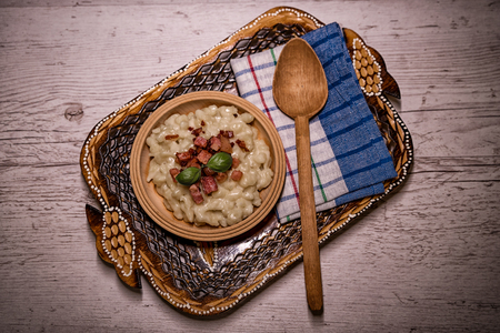 Slovak traditional dishes, potato gnocchi, bryndza, on wooden pancakes, potatoes, eggs. milk, sheep's cheeseの写真素材