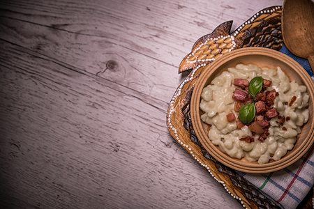 Slovak traditional dishes, potato gnocchi, bryndza, on wooden pancakes, potatoes, eggs. milk, sheep's cheeseの写真素材