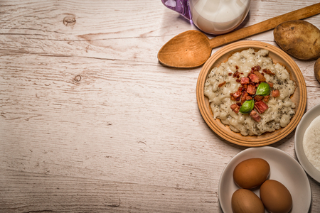 Slovak traditional dishes, potato gnocchi, bryndza, on wooden pancakes, potatoes, eggs. milk, sheep's cheeseの写真素材