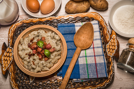 Slovak traditional dishes, potato gnocchi, bryndza, on wooden pancakes, potatoes, eggs. milk, sheep's cheeseの写真素材