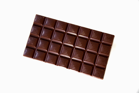 Chocolate. Black chocolate. A few cubes of black chocolate. Chocolate slabs spilled from grated chockolate powder.nutsの写真素材