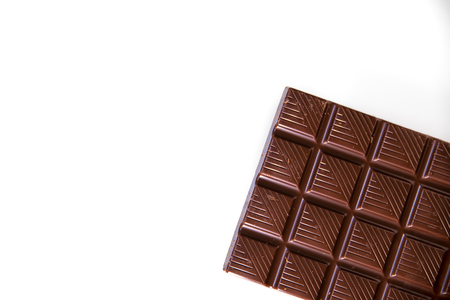 Chocolate. Black chocolate. A few cubes of black chocolate. Chocolate slabs spilled from grated chockolate powder.nutsの写真素材