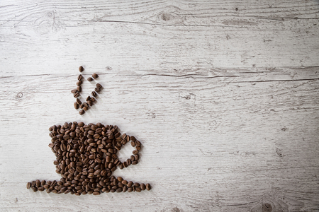 Roasted coffee beans, coffee and background, top view, on wooden backgroundの写真素材