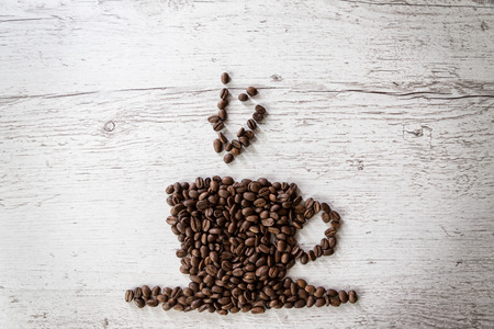 Roasted coffee beans, coffee and background, top view, on wooden backgroundの写真素材