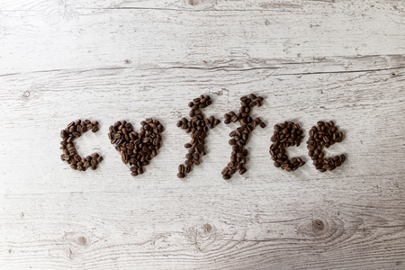 Roasted coffee beans, coffee and background, top view, on wooden backgroundの写真素材