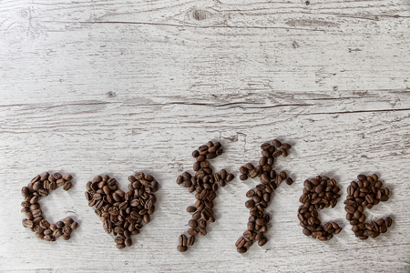 Roasted coffee beans, coffee and background, top view, on wooden backgroundの写真素材