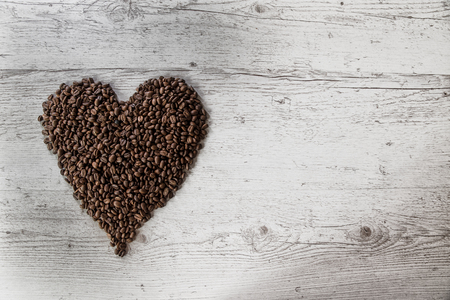Roasted coffee beans, coffee and background, top view, on wooden backgroundの写真素材
