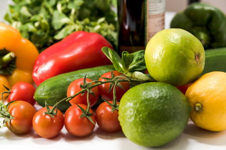 fresh raw vegetables, salad preparation, pepper, tomatoes, cucumber, fresh salad, lime, lemon, cheeseの写真素材