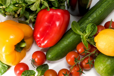 fresh raw vegetables, salad preparation, pepper, tomatoes, cucumber, fresh salad, lime, lemon, cheeseの写真素材
