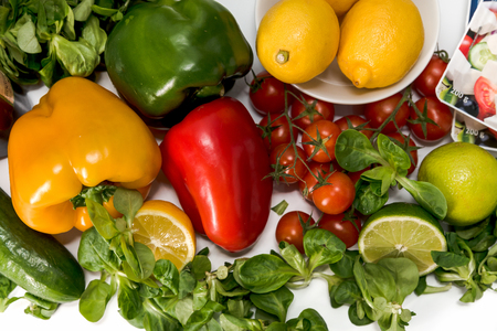 fresh raw vegetables, salad preparation, pepper, tomatoes, cucumber, fresh salad, lime, lemon, cheeseの写真素材