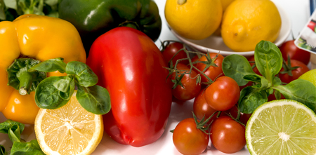 fresh raw vegetables, salad preparation, pepper, tomatoes, cucumber, fresh salad, lime, lemon, cheeseの写真素材