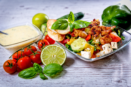 salad, Greek, Italian, tomato mozzarella Basil leaves, peppercorn and olive oil on a wooden table. Recipe - Compositionの写真素材