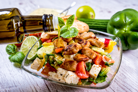 salad, Greek, Italian, tomato mozzarella Basil leaves, peppercorn and olive oil on a wooden table. Recipe - Compositionの写真素材