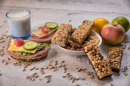healthy breakfast, cereal sticks in mycelium with nuts, two pans of vegetables laid on the tableの写真素材