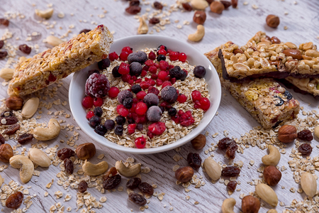 Oatmeal, nuts, woody fruit on wood background, ingredients, healthy foodの写真素材