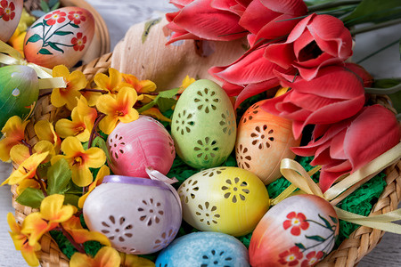 Easter, painted Easter eggs set in a bowl Easter decoration behind a white backgroundの写真素材