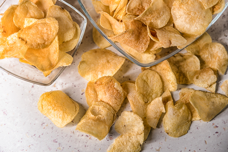potato chips on a plate on a white backgroundの写真素材